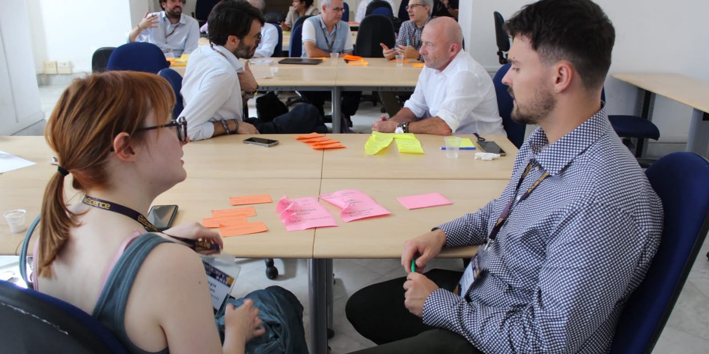 Dr Georgia Atkinson discussing individual perspectives with a workshop attendee