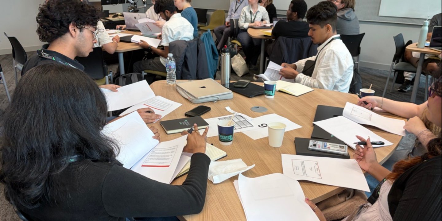 Students looking through business problem packs