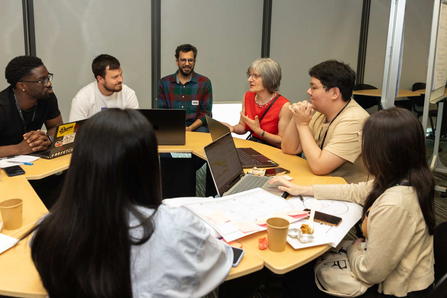 Group of students talking with Stephanie Glendinning, PVC SAgE